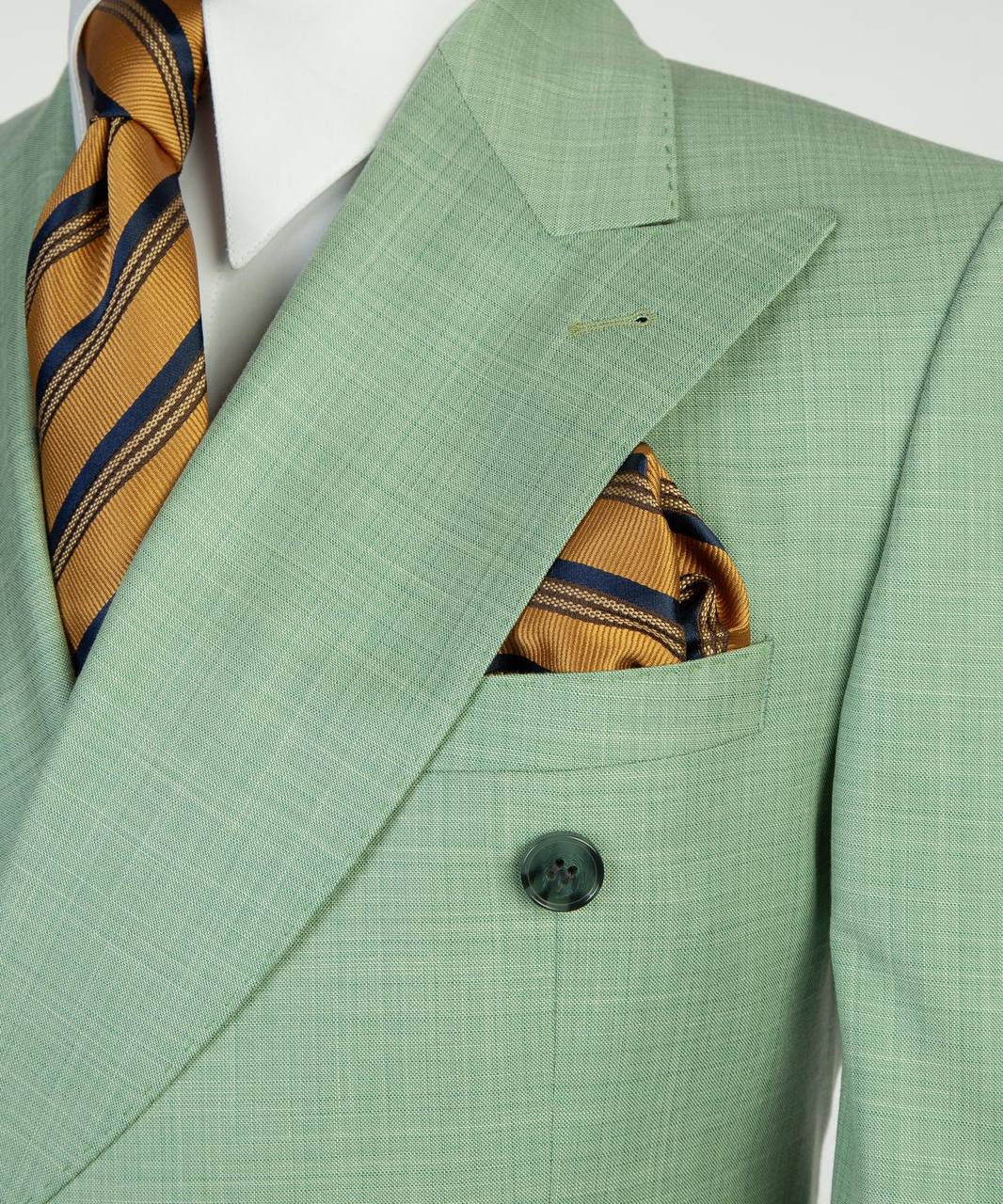 Mint green suit lapel tie and pocket square detail