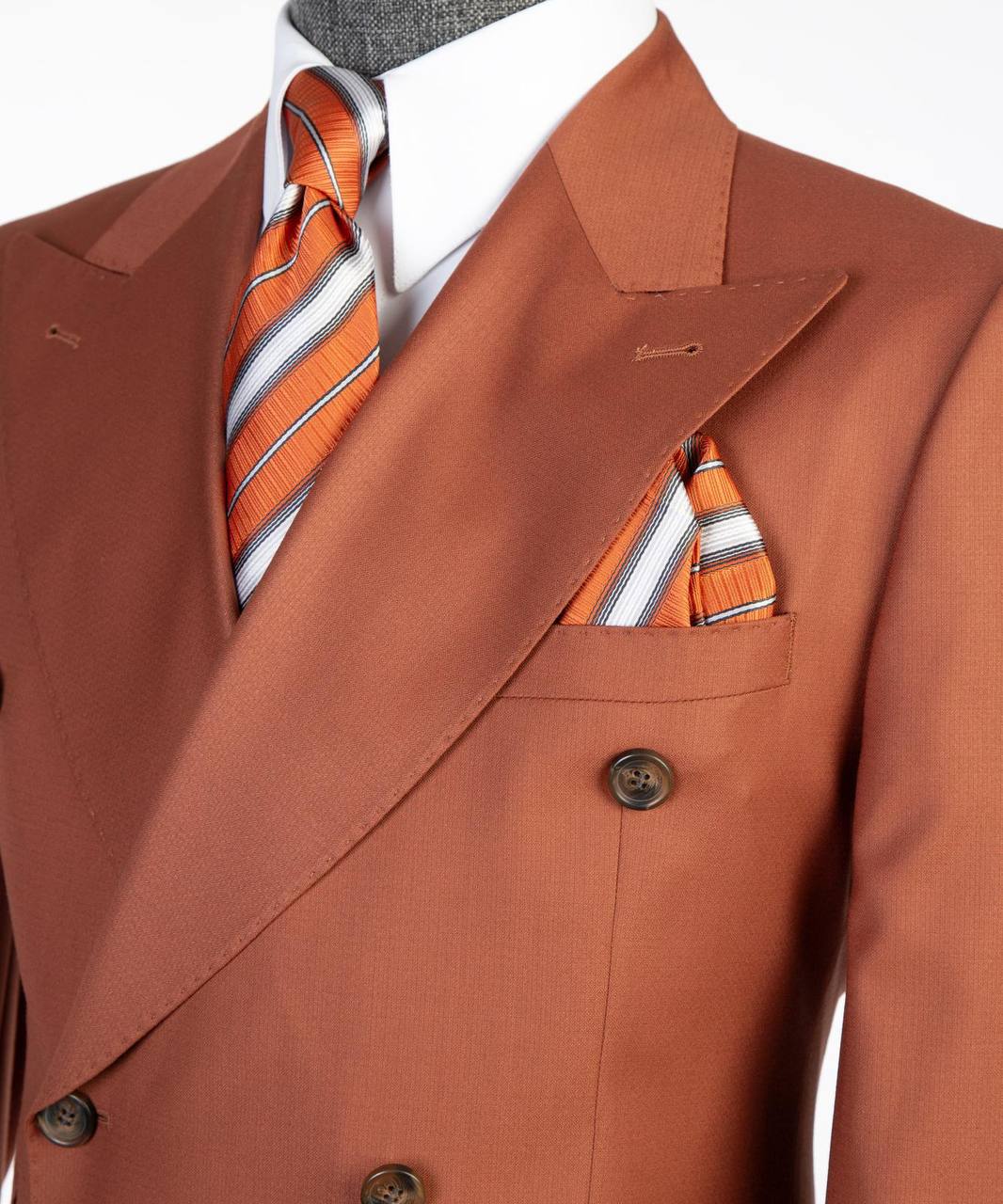 Rust orange double-breasted suit lapel tie and pocket square close-up