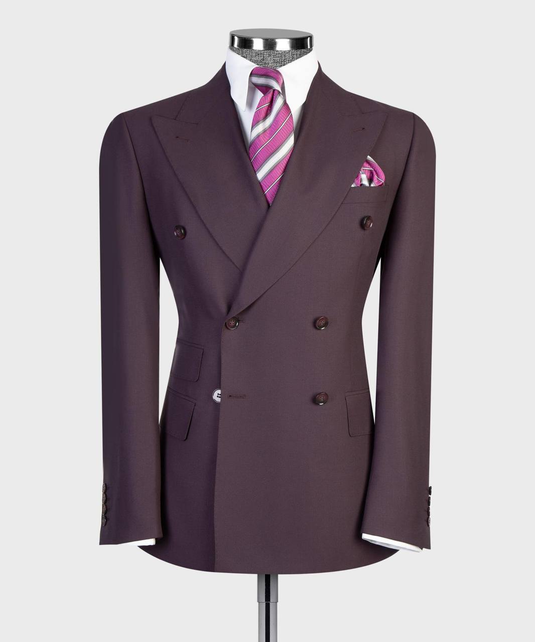Deep plum double-breasted jacket front with striped tie and pocket square
