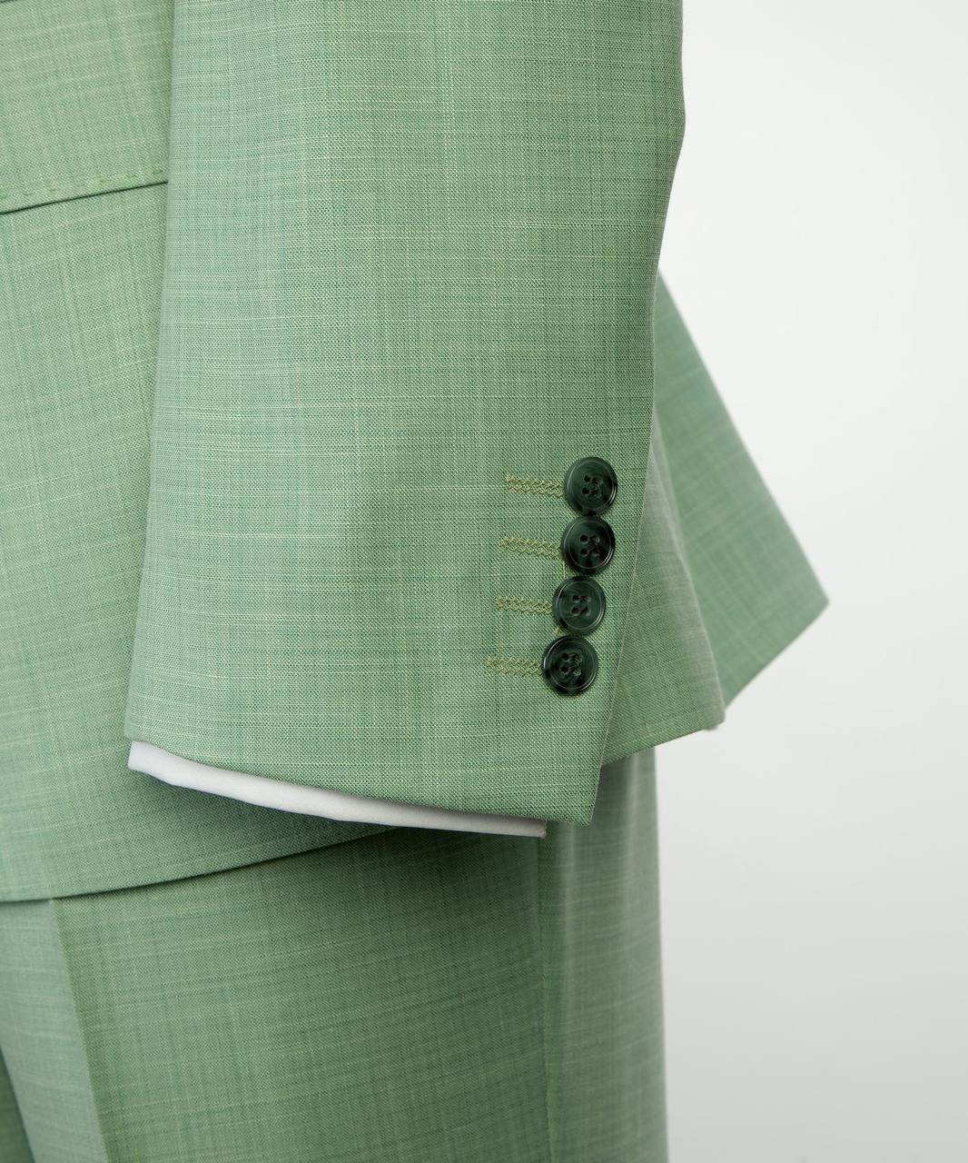 Mint green suit sleeve and button detail