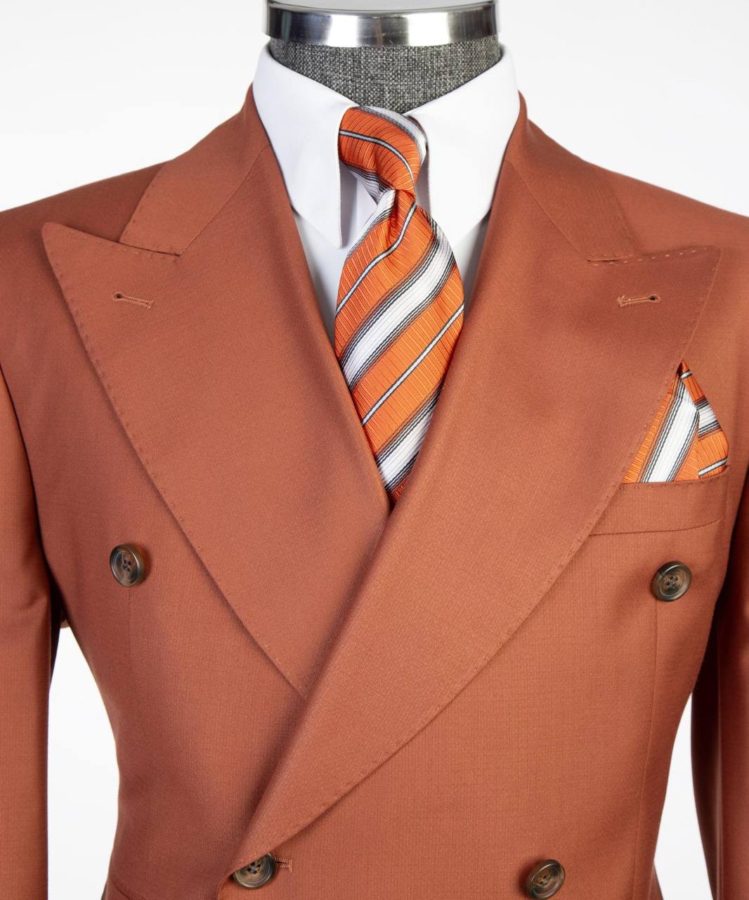 Rust orange suit lapel tie and pocket square detail