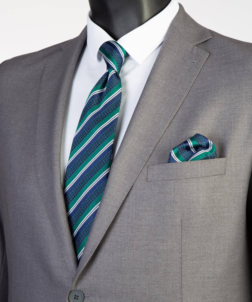 Close-up of gray Super 200’s wool suit jacket with teal striped tie styling