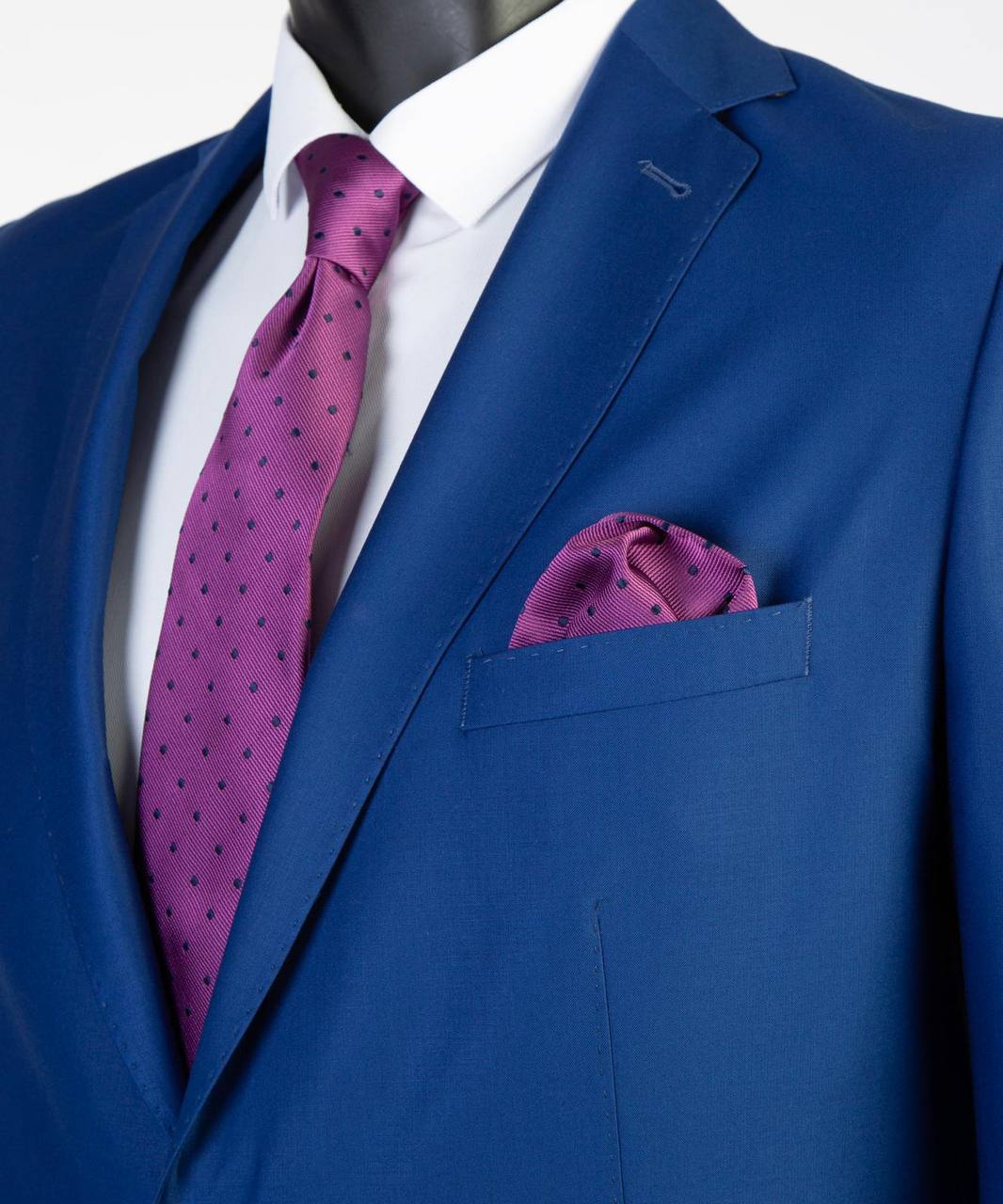 Close-up of royal blue Super 200’s wool suit jacket with magenta styling accents