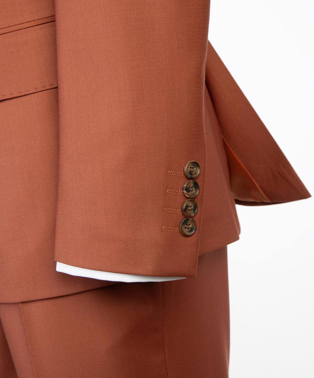 Rust orange suit sleeve cuff and button detail