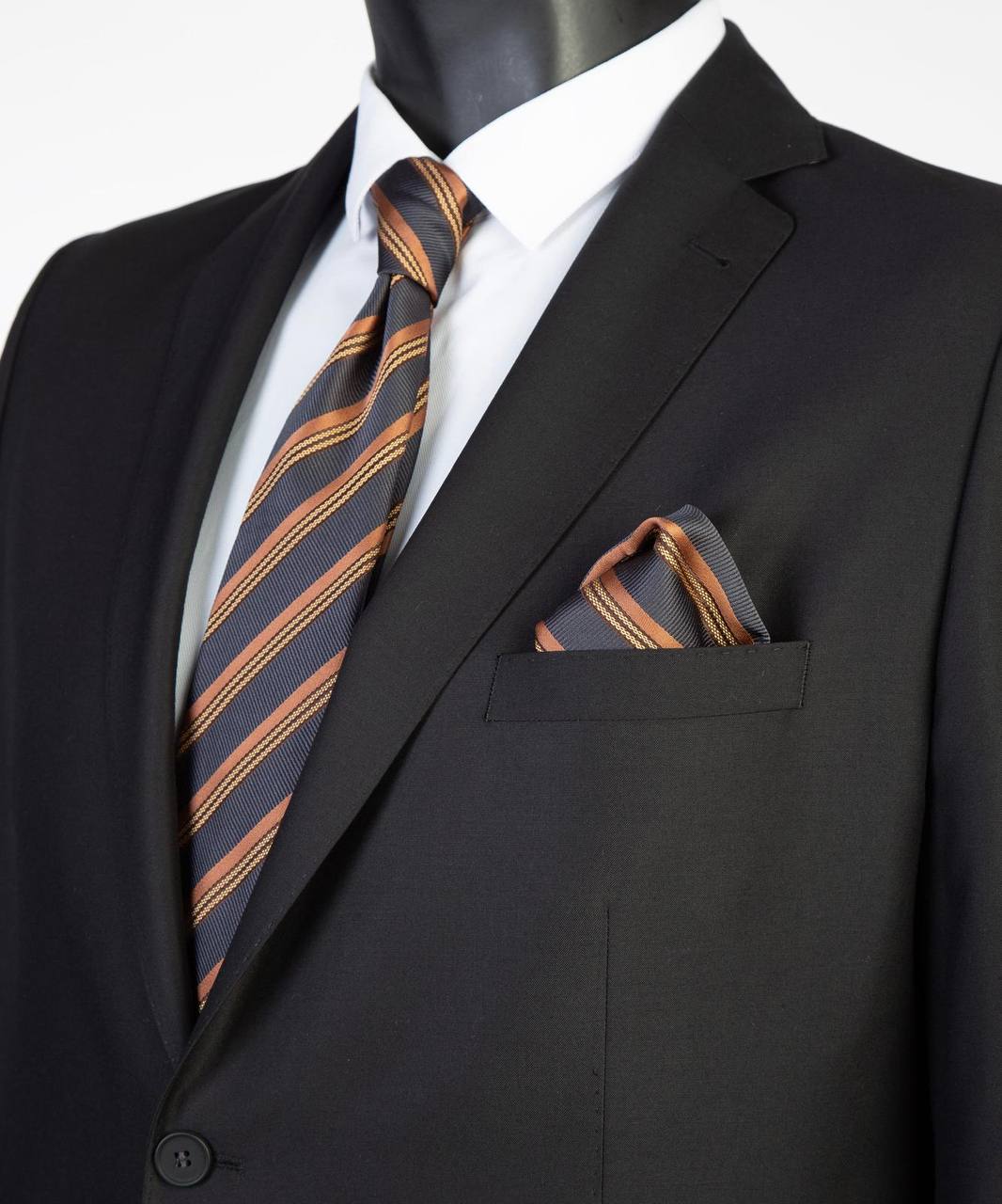 Close-up of black Super 200’s wool suit jacket with striped tie styling