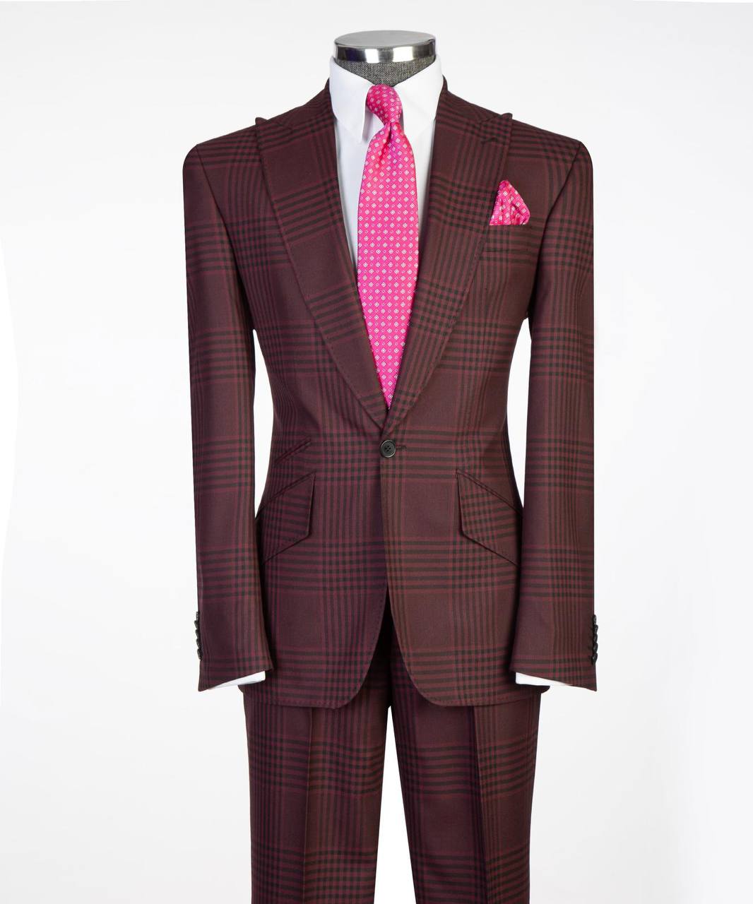 Burgundy plaid two-button suit front view with white shirt and pink tie.