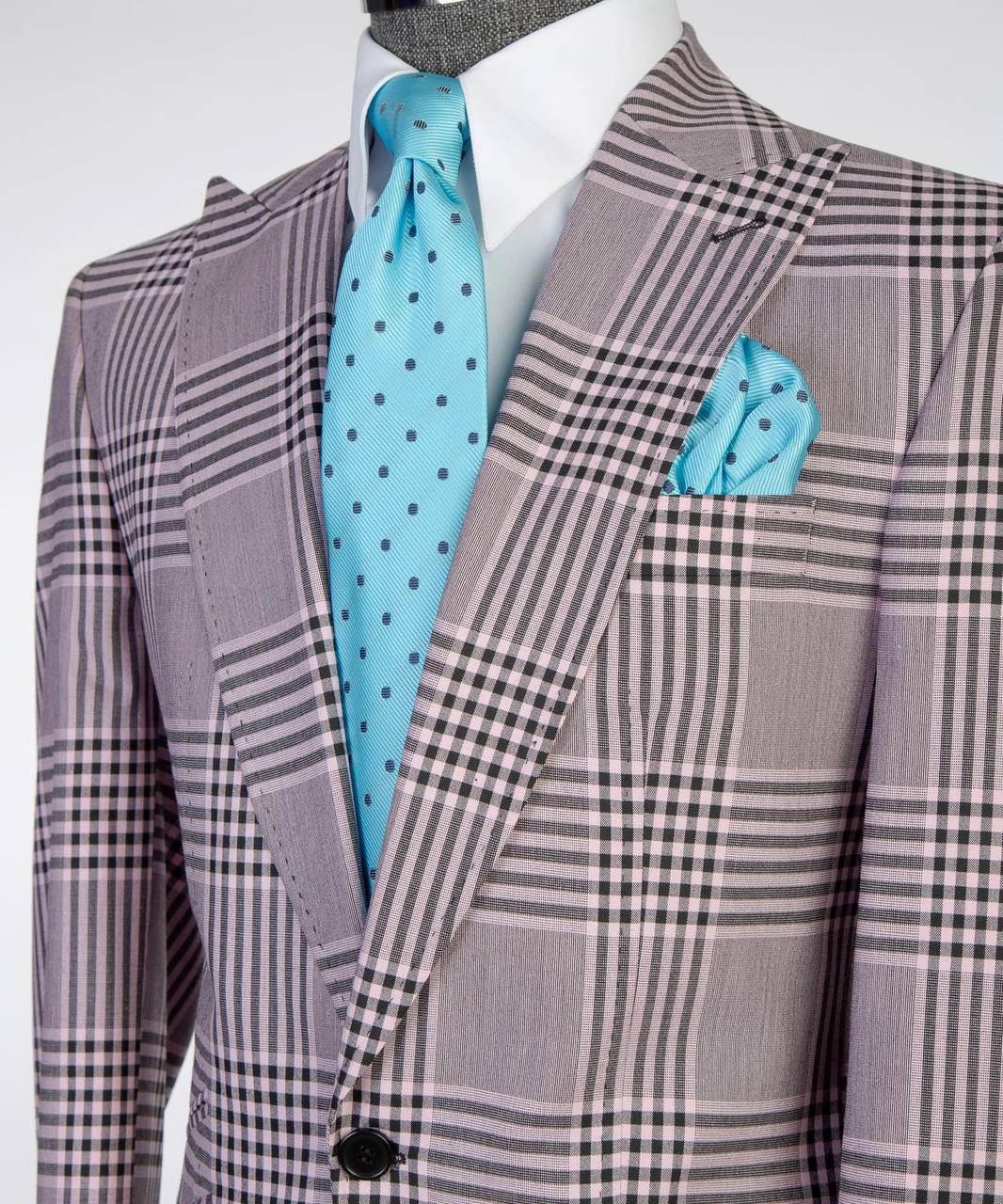 Close-up of lavender gray plaid suit jacket styled with white shirt, turquoise tie, and pocket square.