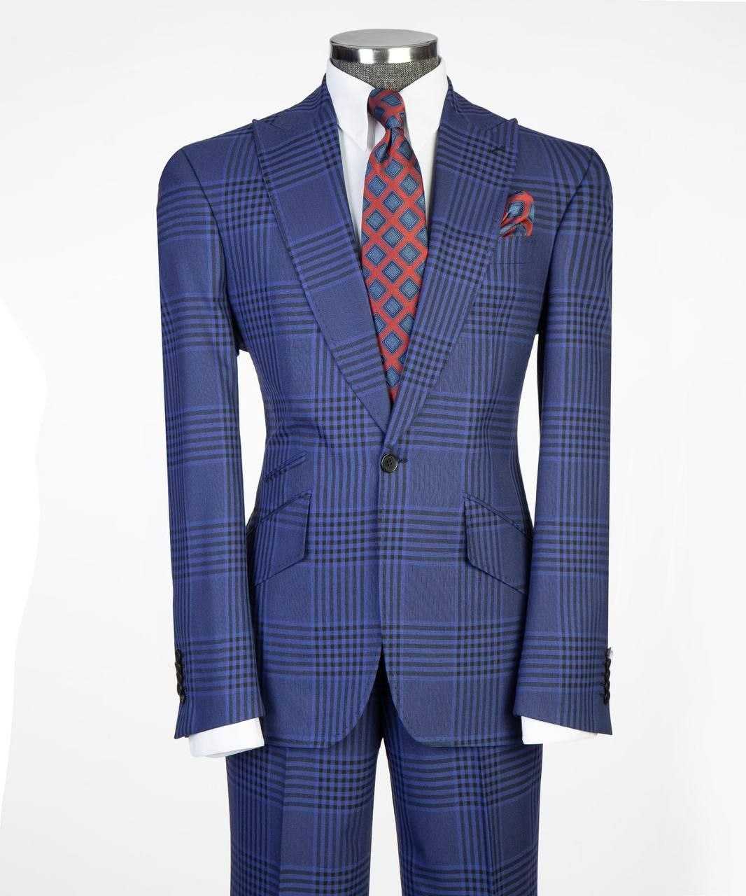 Men’s royal blue plaid two-piece suit on mannequin with white shirt and red patterned tie.