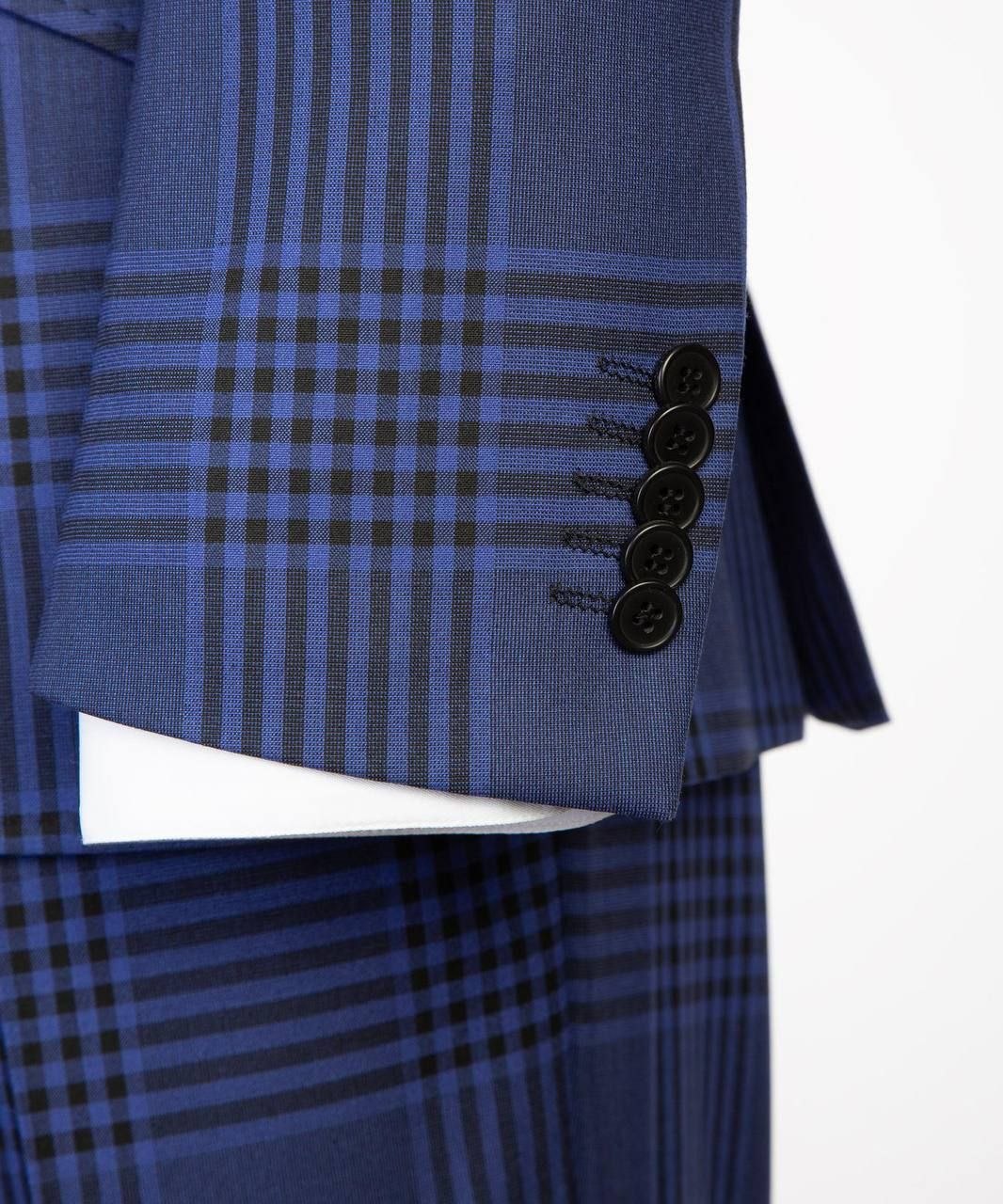 Close-up of royal blue plaid suit sleeve showing dark cuff buttons and fabric pattern.